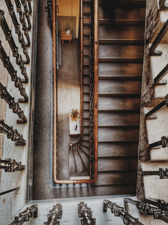 A high angle view of a beautifully designed staircase in Edinburgh, featuring intricate handrails and a warm ambiance.