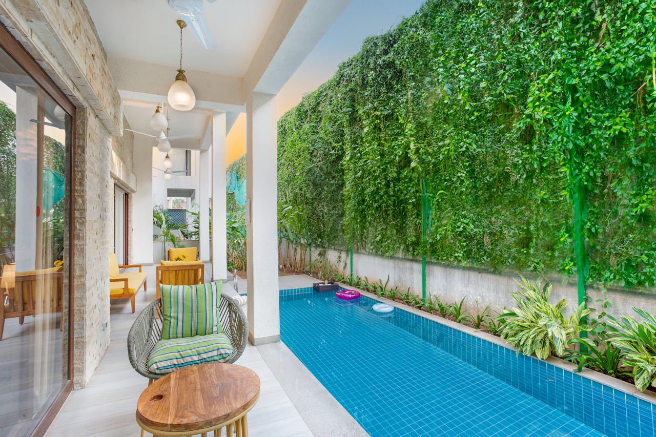 Experience serene luxury in a Goa villa featuring a private pool and lush greenery.